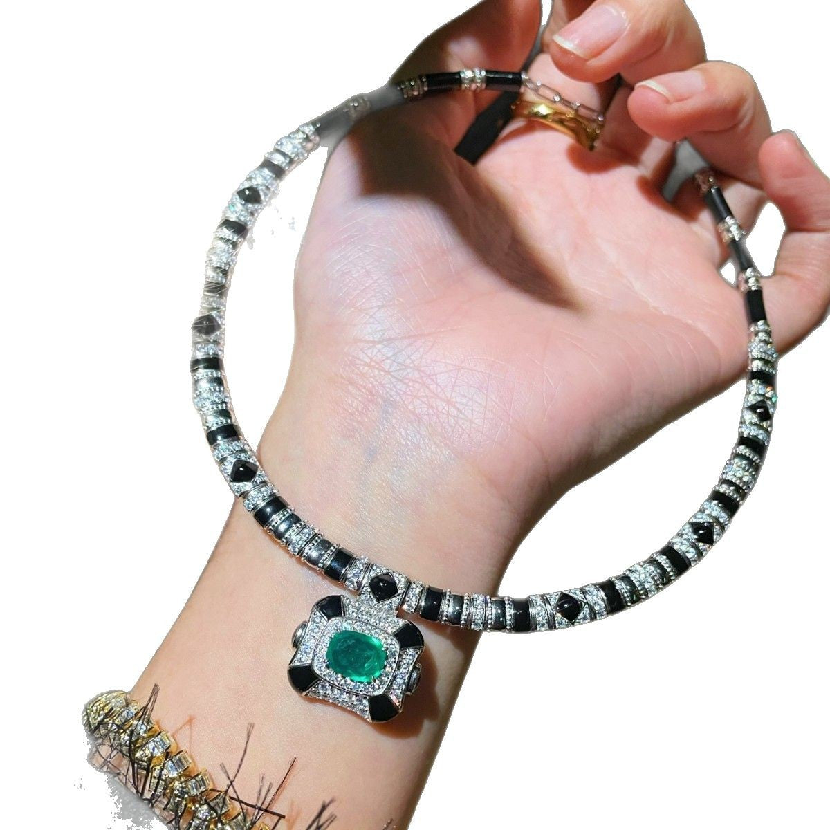 Vintage high-end jewelry design featuring emerald spirit snake necklace set with a luxurious multi chain banquet dress