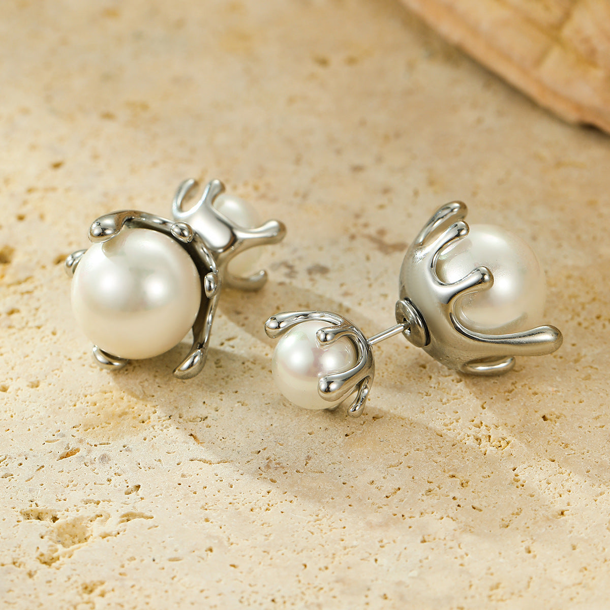 Hot selling earrings with stainless steel earrings inlaid with pearls and a dual directional design, niche earrings