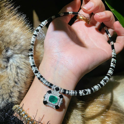 Vintage high-end jewelry design featuring emerald spirit snake necklace set with a luxurious multi chain banquet dress