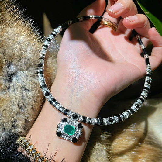Vintage high-end jewelry design featuring emerald spirit snake necklace set with a luxurious multi chain banquet dress