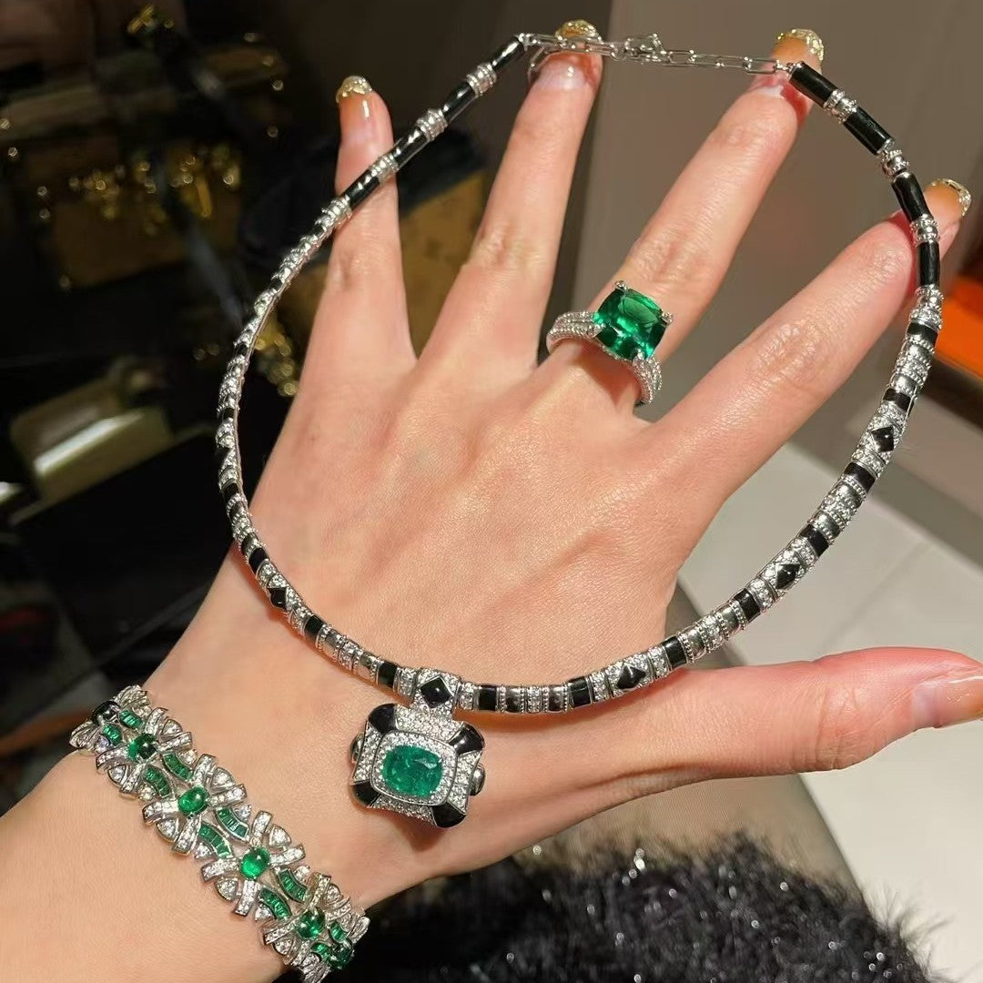 Vintage high-end jewelry design featuring emerald spirit snake necklace set with a luxurious multi chain banquet dress